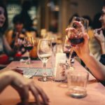 A festive dining scene with a waiter receiving a tip, symbolising the fair distribution of tips under the Employment (Allocation of Tips) Act 2023.