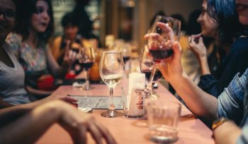 A festive dining scene with a waiter receiving a tip, symbolising the fair distribution of tips under the Employment (Allocation of Tips) Act 2023.