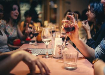 A festive dining scene with a waiter receiving a tip, symbolising the fair distribution of tips under the Employment (Allocation of Tips) Act 2023.